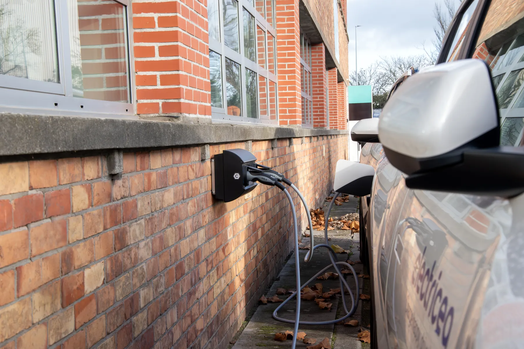 Een bedrijfswagen laadt thuis aan een wallbox